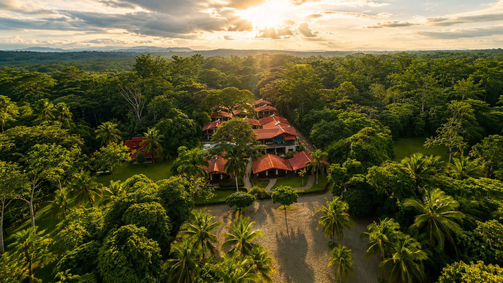 Aerial view of Blue Morpho beachfront pavilions, pool and gardens between rainforest and the Pacific